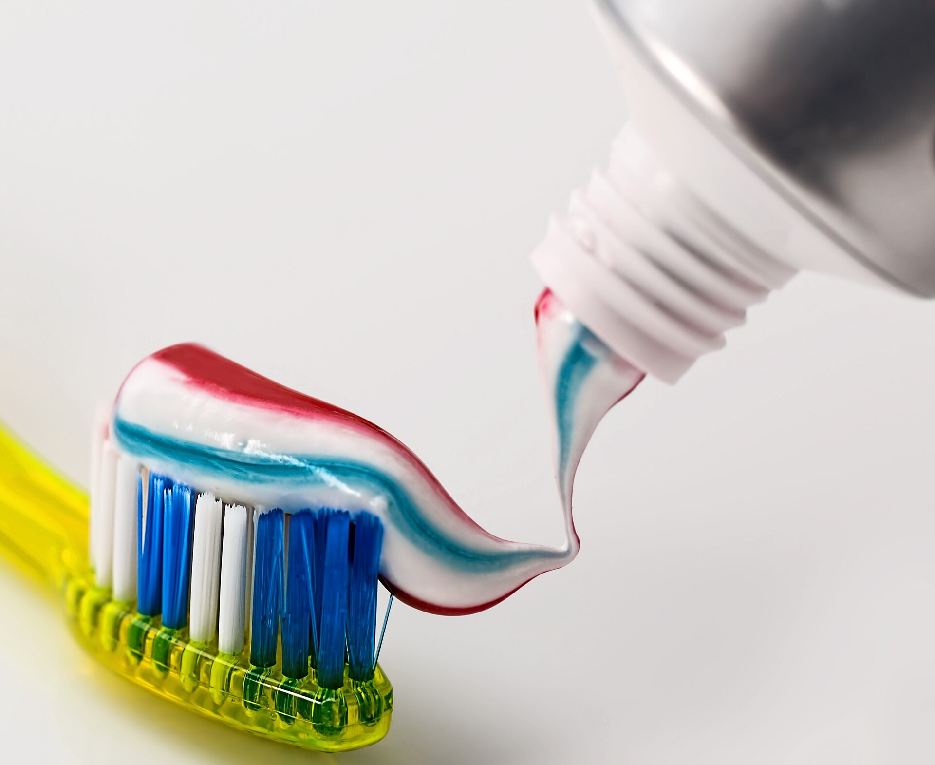 A toothbrush with a stripe of toothpaste.